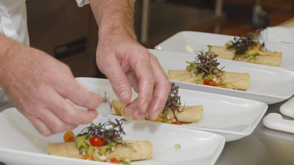 Chef plating dishes in a restaurant kitchen